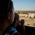 mother and daughter admiring rhinoceroses through 2024 09 23 04 00 15 utc