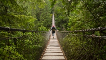 woman on lynn canyon suspension bridge north vanc 2024 06 18 19 18 19 utc 1